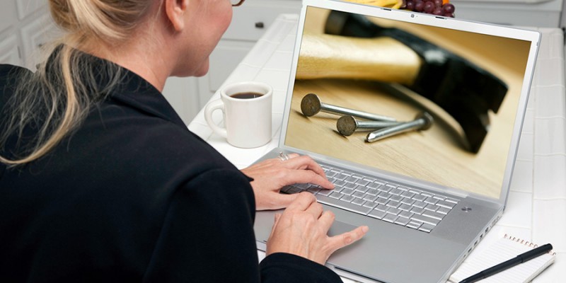 Woman In Kitchen Using Laptop to Research Home Improvement. Screen can be easily used for your own message or picture. Picture on screen is my copyright as well.